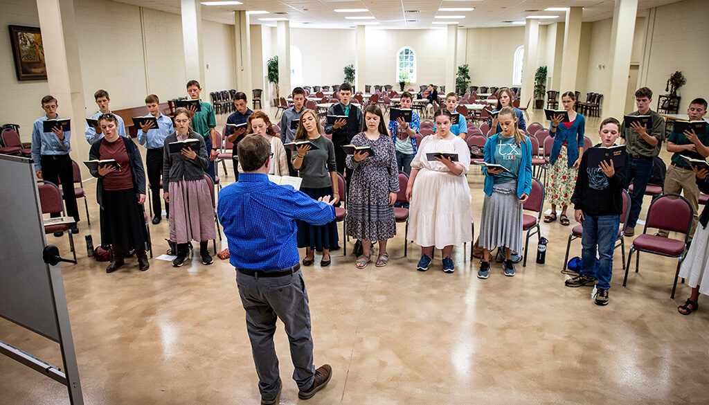 High school choir students practicing their pieces in the Shrine.