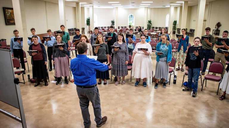 High school choir students practicing their pieces in the Shrine.