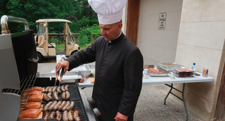 A minister tending the grill for a fun local BBQ event at the Guadalupe Shrine Church.