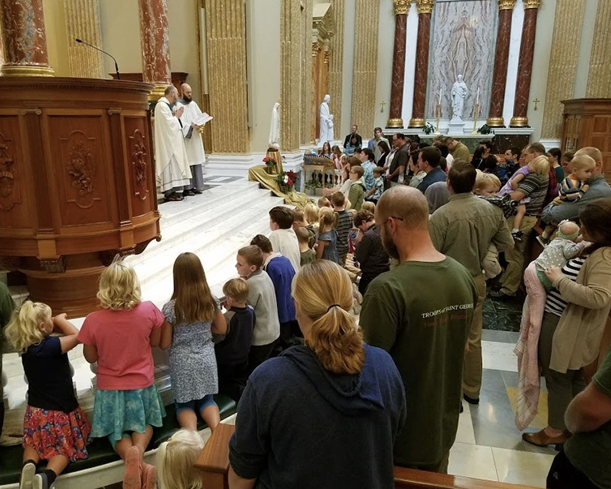 Congregation members participate in a prayer during mass at Our Lady of Guadalupe Shrine in La Crosse, Wisconsin.