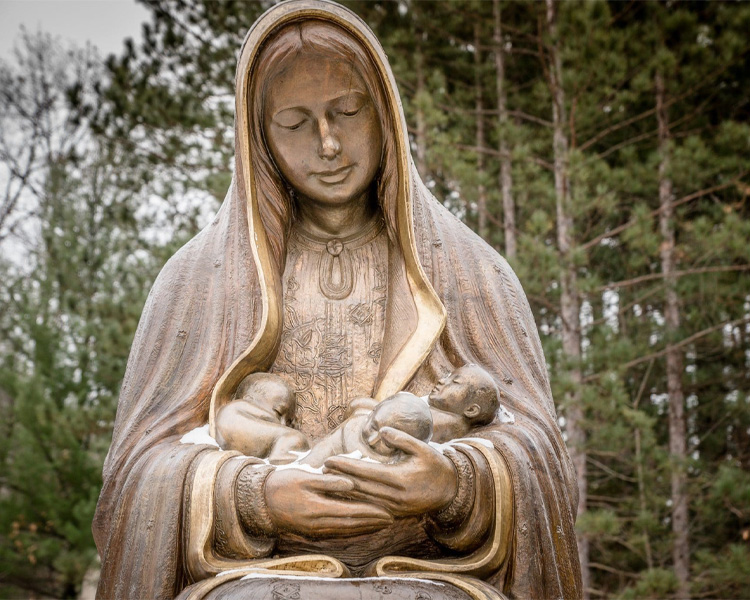 Statue of Our Lady of Guadalupe holding three babies at Our Lady of Guadalupe Shrine in La Crosse, Wisconsin.