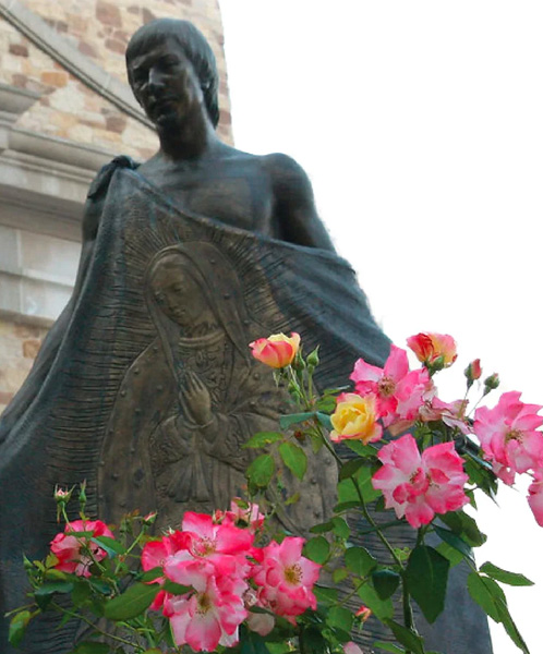 Flowers blooming around the statue of Juan Diego at Our Lady of Guadalupe Shrine in La Crosse, Wisconsin.