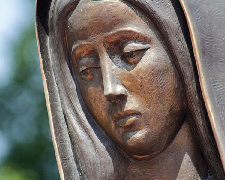 Close up of a statue of Mary looking solemn at Our Lady of Guadalupe Shrine in La Crosse, Wisconsin.