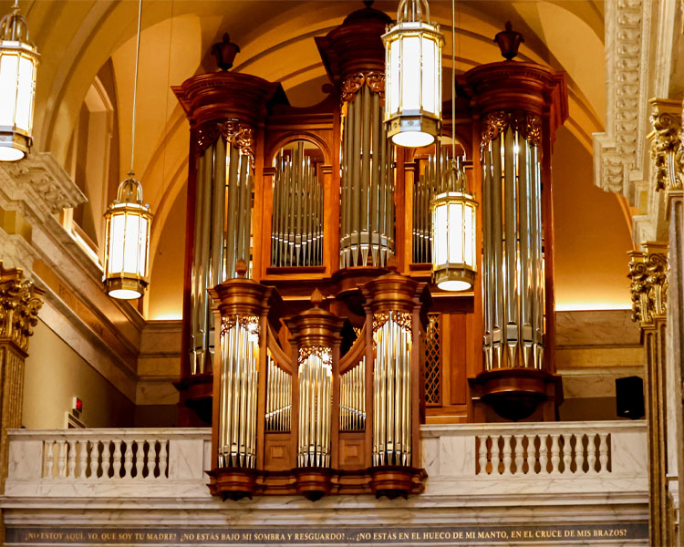 Close up of the organ with a Spanish proverb underneath at Our Lady of Guadalupe Shrine in La Crosse, Wisconsin.