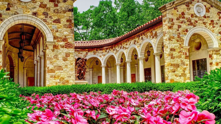 Pink flowers and green landscaping in front of the Memorial to the Unborn at The Shrine of Our Lady of Guadalupe in La Crosse, Wisconsin.