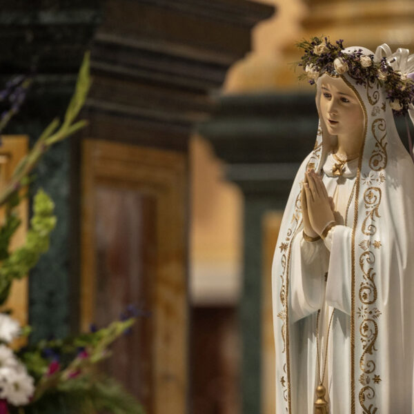 Statue of Mother Mary wearing a floral crown and praying at Our Lady of Guadalupe Shrine in La Crosse, Wisconsin.