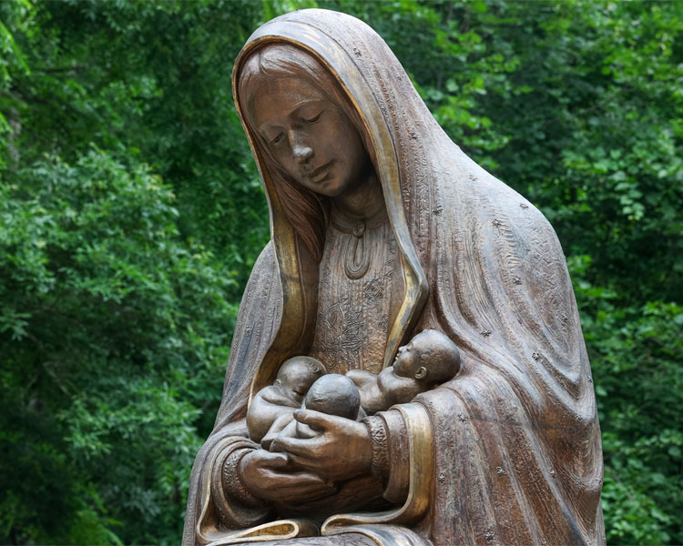 Closeup of the statue of Our Lady of Guadalupe holding three babies at The Shrine of Our Lady of Guadalupe in La Crosse, Wisconsin.