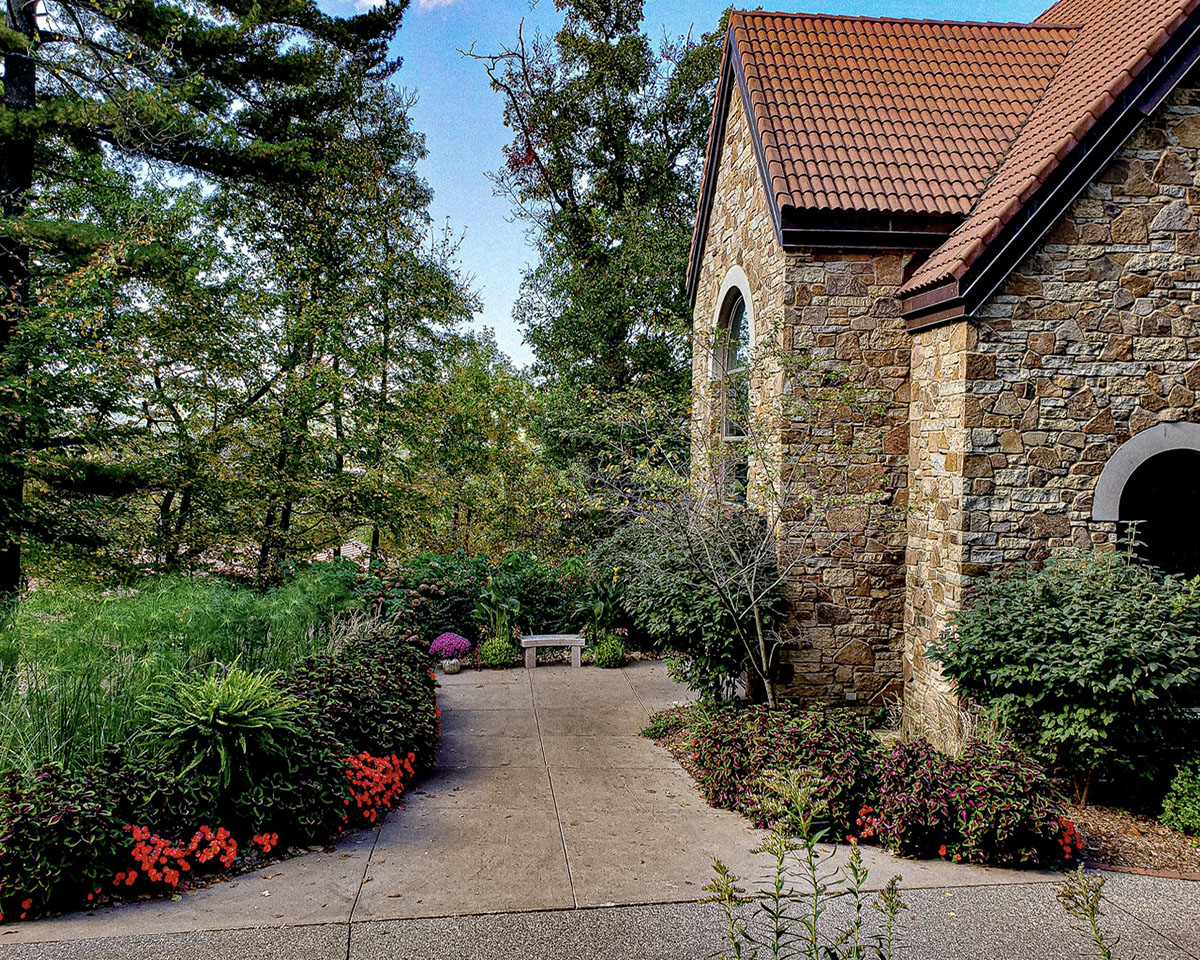 Landscaped walkway path leading to the Votive Candle Chapel at Our Lady of Guadalupe Shrine in La Crosse, Wisconsin.