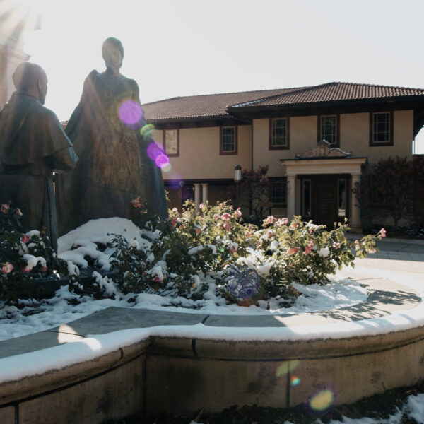 Snow covered statue of Juan Diego in the courtyard of Our Lady of Guadalupe Shrine in La Crosse, Wisconsin.