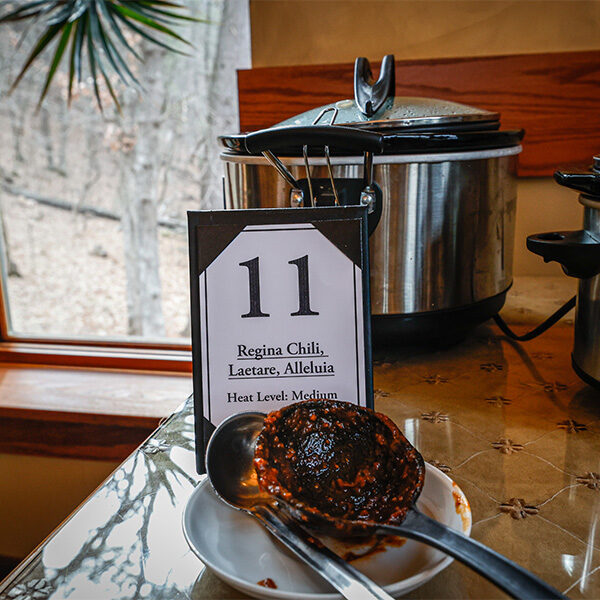 A closeup of a crockpot full of chili for contestant number 11 called, Regina Chili, Laetare, Alleluia. Heat level: Medium.