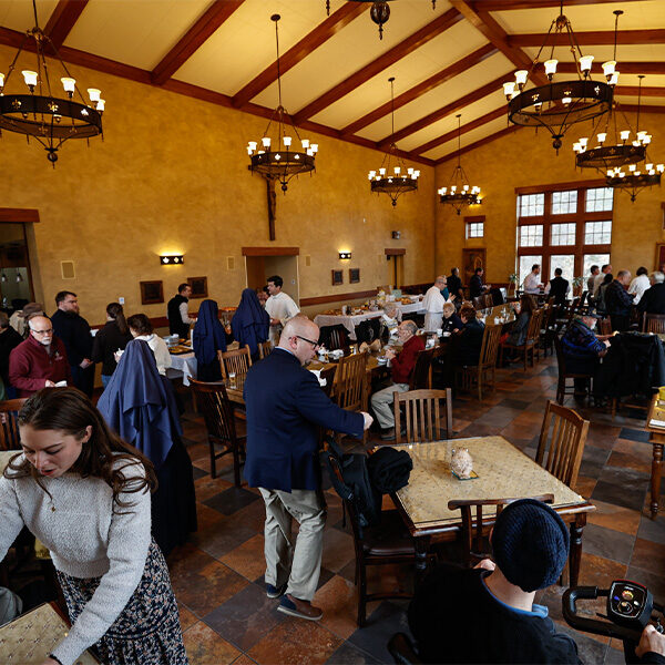 Staff and volunteers enjoying each other's company and food during the chili cookoff in the beautiful warmth of the Shrine cafe.