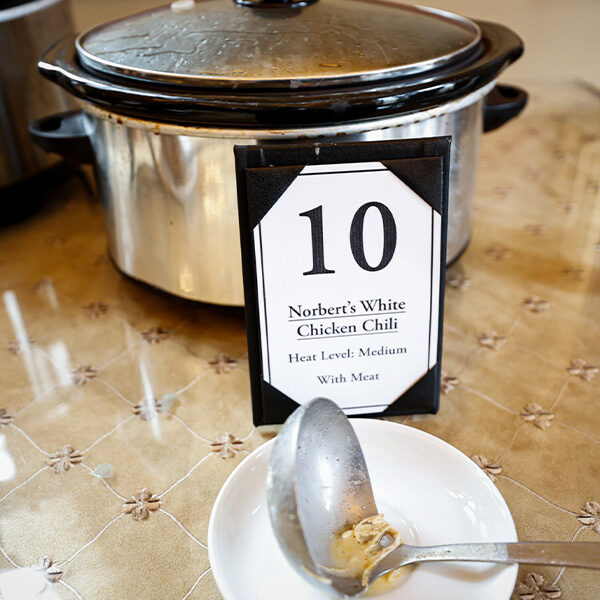 A closeup of a crockpot of chili for contestant number 10, named Norbert's White Chicken Chili. Heat Level: Medium.