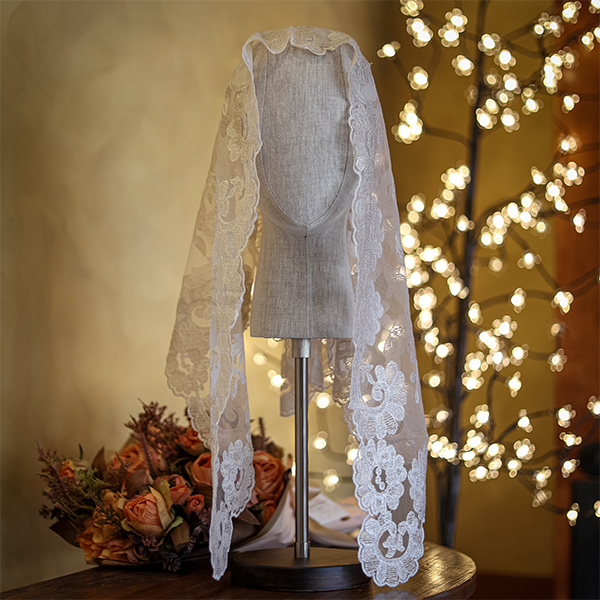 A white lacy floral veil in the Shrine giftshop.