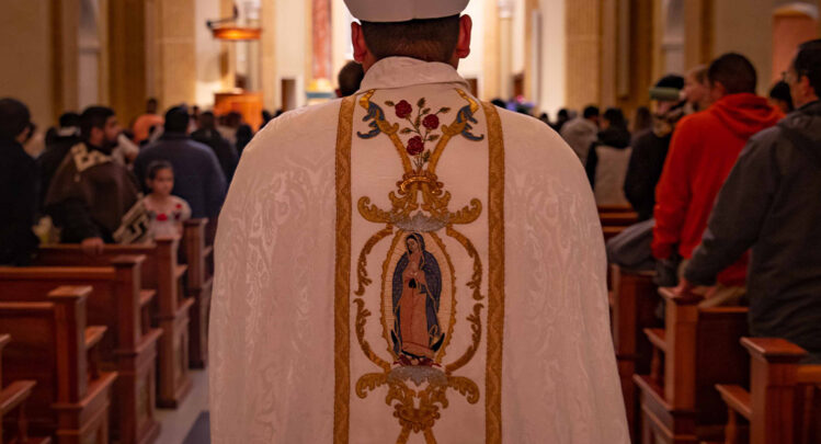 A Norbertine Priest walking down the Shrine church isle for Mass Prayer.