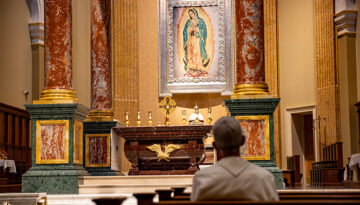 what is a pilgrimage - norbertine praying in church with eucharistic adoration with tilma of mary in background