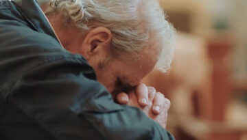 A man praying at the Shrine of Our Lady of Guadalupe in La Crosse, WI