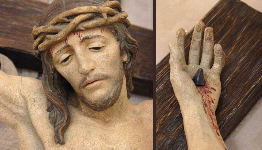 A closeup of Jesus Christ and his pinned hand.