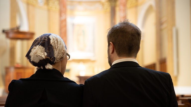 Married Couple Praying together at The Shrine of Our Lady of Guadalupe