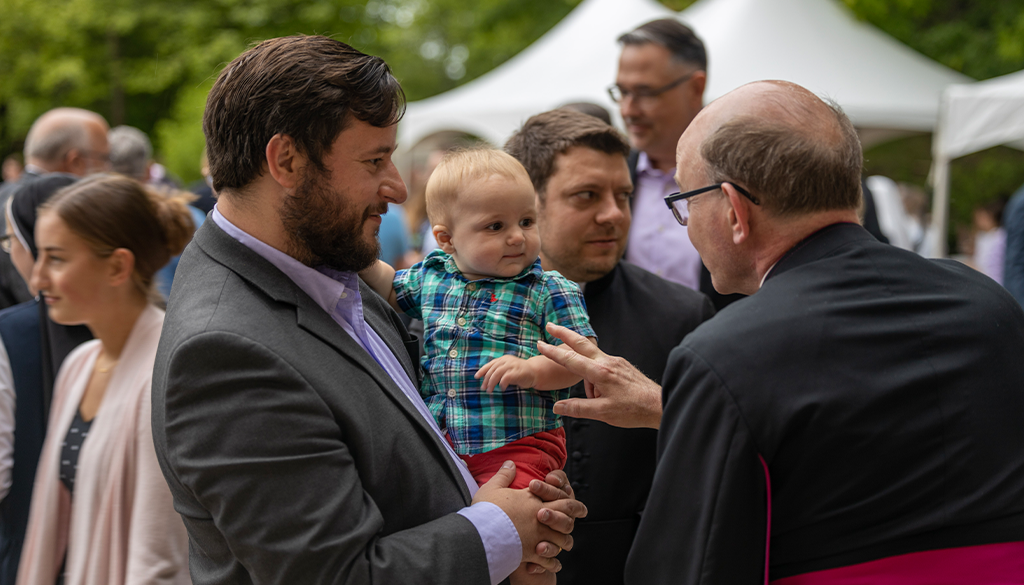 Catholic father with priest at the Shrine of Our Lady of Guadalupe