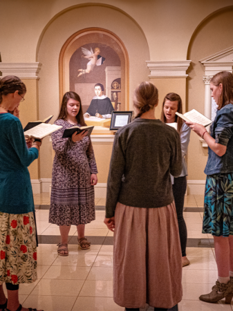 Girls singing together in the basement of the Shrine Church