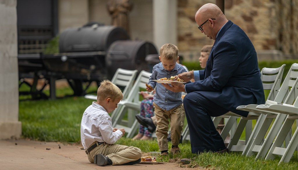 father and sons in Sunday best at Shrine BBQ social