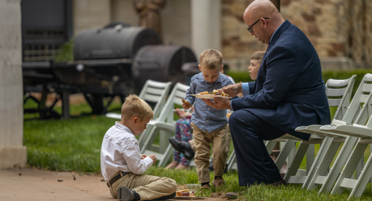 father and sons in Sunday best at Shrine BBQ social