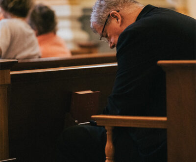 Man praying with his head bowed