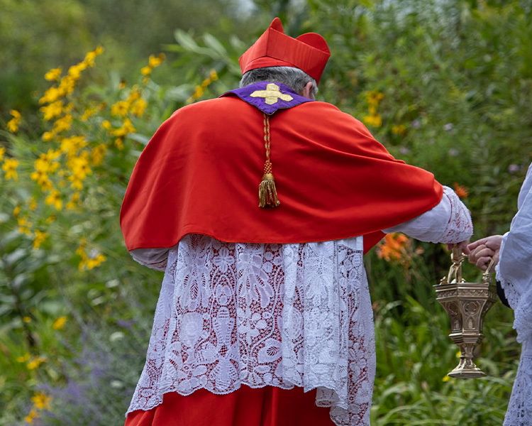 Cardinal Burke blessing the Shrine with aspersorium and aspergillum