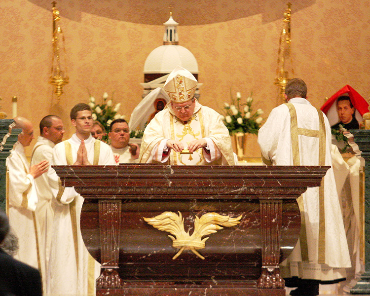 Cardinal Burke inserting relic into the Altar at the Shrine of Our Lady of Guadalupe