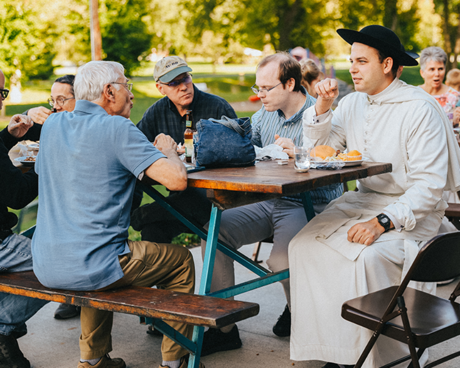 Catholic Church Picnic with Shrine Staff eating at park picnic tables