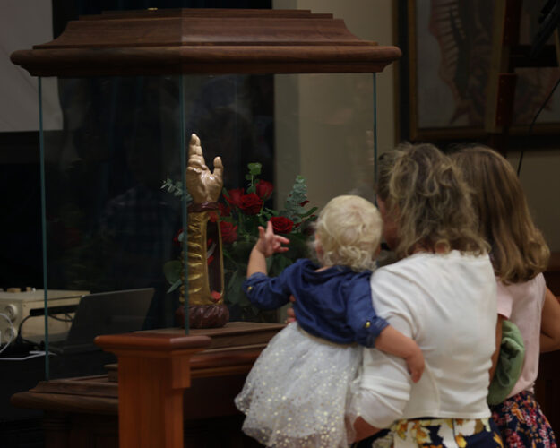 Family venerating the Arm of Saint Jude at the Guadalupe Shrine