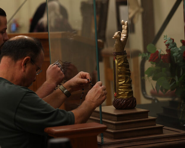 Men creating a third class relic from the Arm of St. Jude