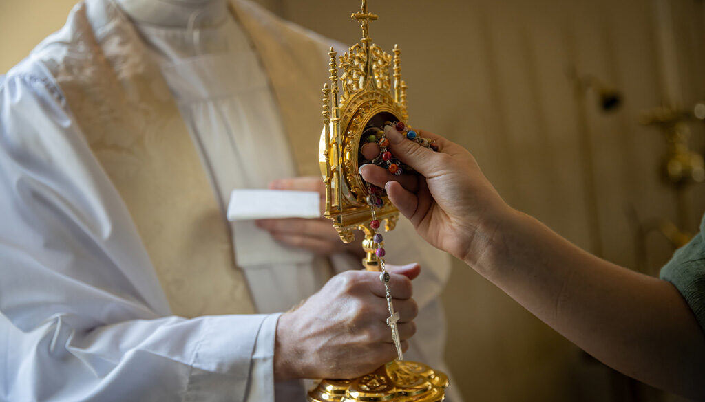 Rosary touching a saint's relic, creating a third class relic