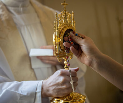 Rosary touching a saint's relic, creating a third class relic