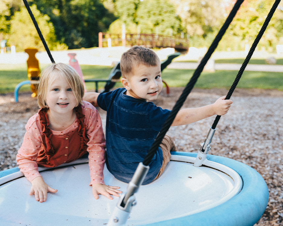 children on swing picnic at the park