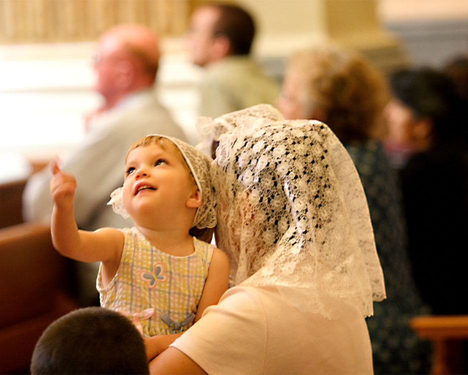 Child gazing at the Shrine Church dome in wonder and awe