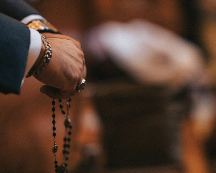 Hands folded in prayer with the rosary