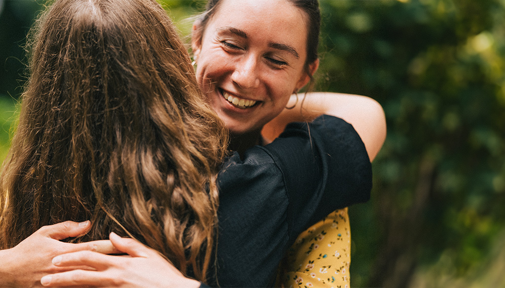 Maggie_smiling_while_huggind_shrine_staff_memeber