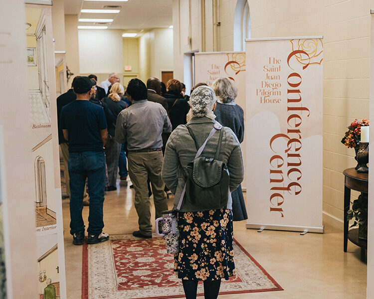 Pilgrim walking through shrine Crypt with pilgrim house display