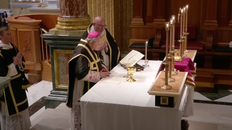 A Solemn Pontifical Requiem Mass at the Shrine of Our Lady of Guadalupe in La Crosse, Wisconsin, celebrated on All Souls' Day, November 2, 2024, with clergy in traditional black and gold vestments gathered at the altar.