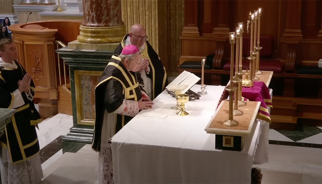 A Solemn Pontifical Requiem Mass at the Shrine of Our Lady of Guadalupe in La Crosse, Wisconsin, celebrated on All Souls' Day, November 2, 2024, with clergy in traditional black and gold vestments gathered at the altar.