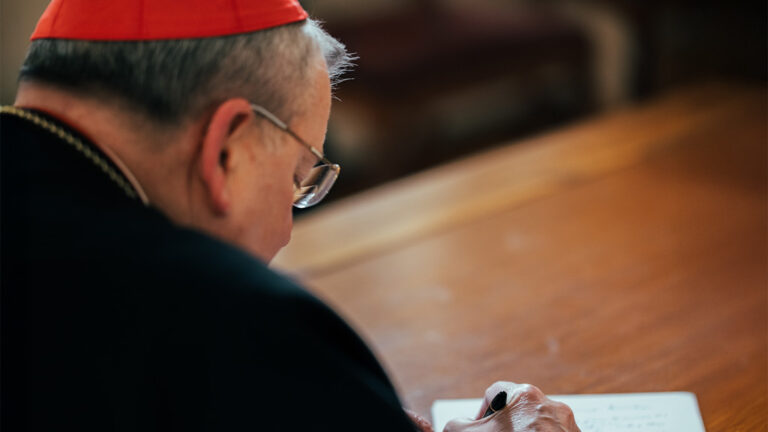 Cardinal Burke Signing a Letter