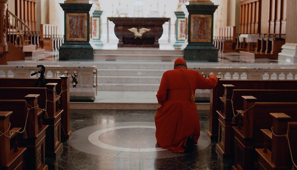 Cardinal Burke genuflecting