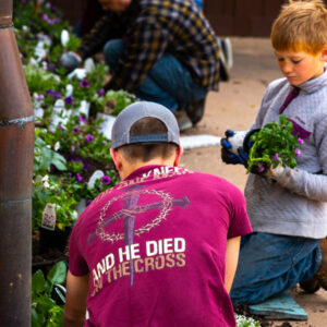 Young volunteers planting flowers for the Shrine grounds in la crosse, wisconsin